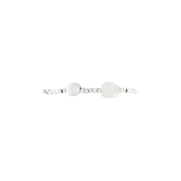 Silver bracelet with a large round white stone on a white background